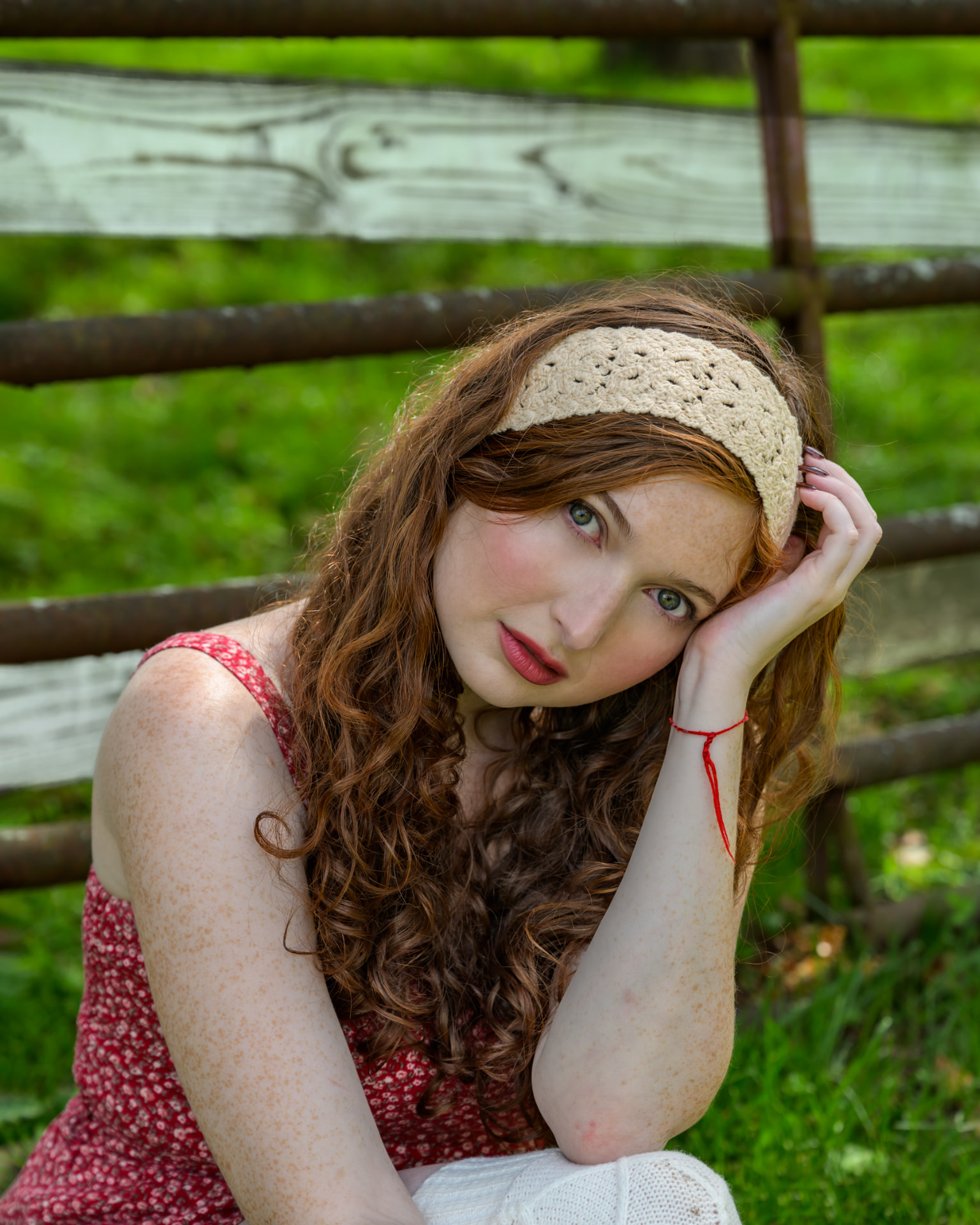 Victoria Yoffe in a crochet headband resting her head on her hand